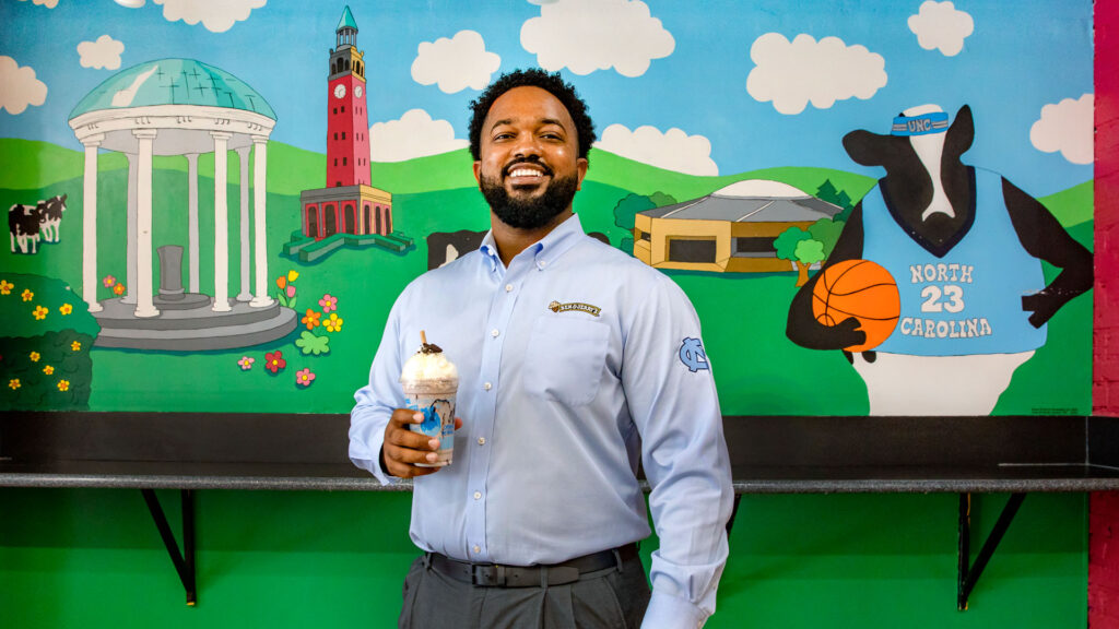 Antonio McBroom '08 poses for a portrait inside of the Ben & Jerry's franchise that he owns on Franklin Street in Chapel Hill.